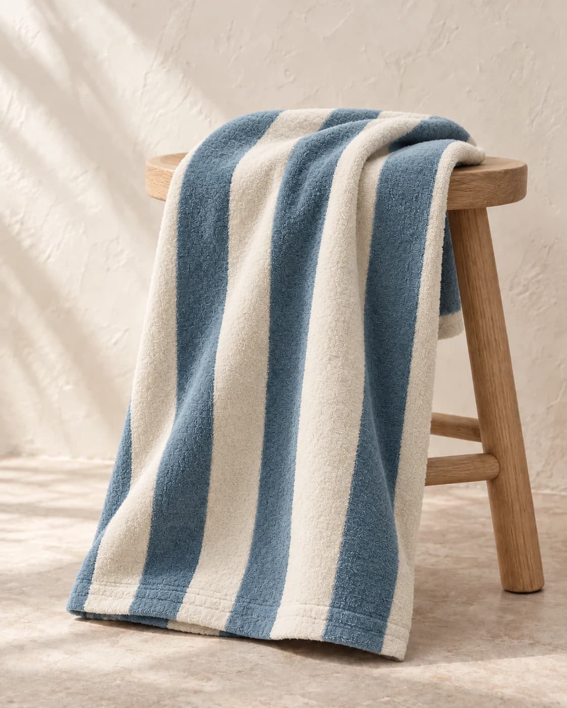 the swim towel in dusty blue, showing its texture and finish