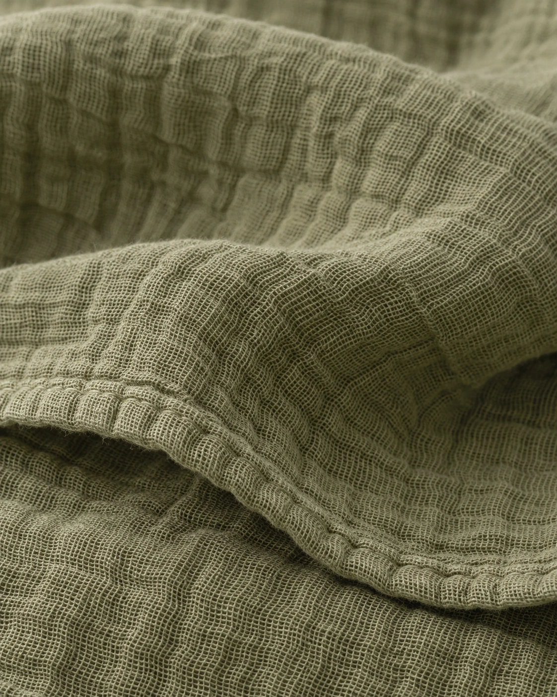 Olive cotton muslin with fine gauze threads, washed crinkles and a softly folded edge